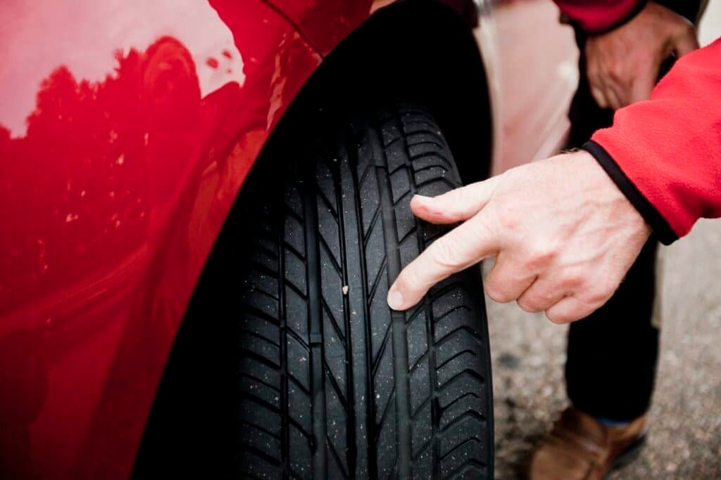 man checking car tyre inspection