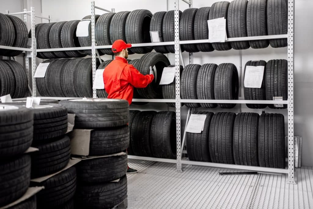 warehouse tyres stacked with worker